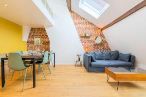 a living room with a blue couch and a table at Charming bright flat in Vieux Lille. in Lille