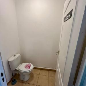 a bathroom with a toilet with a pink flower on the seat at Thubaneau St Charles Canebière Vieux port in Marseille