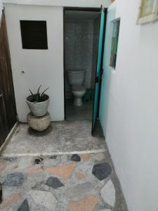 une porte ouverte menant à une salle de bains pourvue de toilettes. dans l'établissement Hotel low cost, à La Dorada