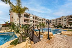 a resort with a swimming pool and a resort at Sunny View - A Stunning Apartment With Private Rooftop in Paphos