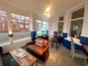 a living room with a couch and a table at The Fossil Tree Hotel in Blackpool