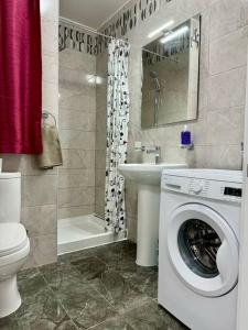 a bathroom with a washing machine and a sink at MIVE-Delux Three Bedroom Apartment in Marsaskala in Marsaskala