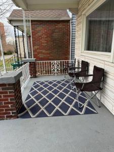 a patio with a table and chairs on a house at Comforting getaway-sleeps 6-walk to falls! in Niagara Falls