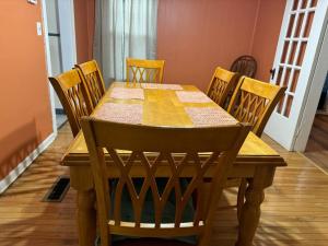 a dining room table with chairs and a table and a table and chairsuggest at Comforting getaway-sleeps 6-walk to falls! in Niagara Falls