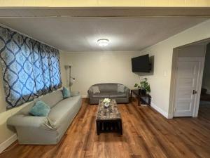 a living room with a couch and a table at Comforting getaway-sleeps 6-walk to falls! in Niagara Falls