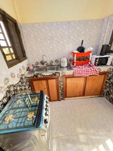a kitchen with a sink and a counter top at Zombré in Ouagadougou