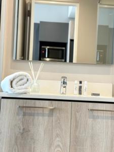 a bathroom with a sink and a mirror at The Trilogy Apartment MM 51011 in Pretoria