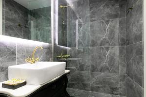 een badkamer met een wastafel en een spiegel bij Vibrant Studio Close To Panepistimio Metro-Zaloggou str in Athene