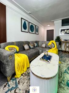 a living room with a couch and a table at Queens&Kings Garden in Nairobi