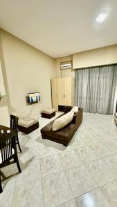 a large living room with a couch and a tv at Eno’s Apartment 2 in Vlorë