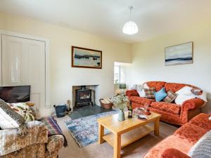 a living room with couches and a fireplace at 3 bed in Carron CA227 in Carron
