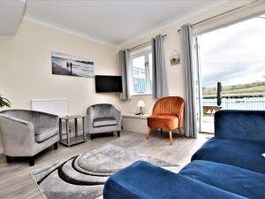 a living room with a blue couch and chairs at 2 Bed in Bideford RIVES in Bideford