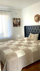 Schlafzimmer mit einem großen Bett mit einem schwarzen Kopfteil in der Unterkunft Villa LA in Landskrona