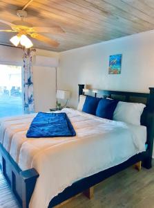 a bedroom with a large bed with a ceiling fan at Exuma Palms Resort in Hermitage