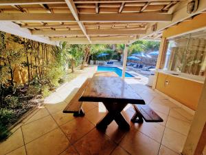 a wooden table on the patio of a house at CASA DA EDINHA in Búzios