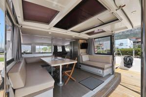 an interior of a rv with a table and chairs at Catamarano 43 Foil e Kite Equipment in Marina di Portisco