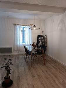 sala de estar con mesa, sillas y una pintura en T2 Ultra Cosy En Hypercentre, en Tarare