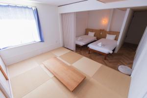 Postel nebo postele na pokoji v ubytování Square 8 HAKUBA RETREAT by UNPLAN