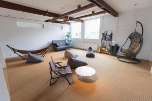a living room with a couch and a table and chairs at Square 8 HAKUBA RETREAT by UNPLAN in Hakuba