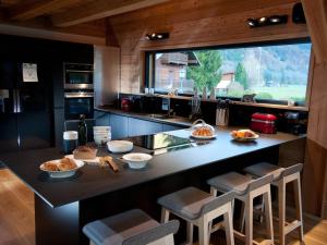 a kitchen with a large counter with a large window at Chalet de 4 chambres a Samoens a 700 m des pistes avec jacuzzi jardin amenage et wifi in Samoëns