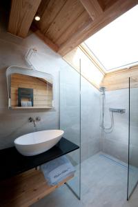 a bathroom with a sink and a shower at Chalet de 4 chambres a Samoens a 700 m des pistes avec jacuzzi jardin amenage et wifi in Samoëns