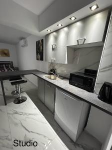 a kitchen with a counter with a sink and a microwave at Maria’s studio in Paphos City