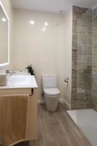 a bathroom with a toilet and a sink and a shower at Non Stress Nuevo Turia in Valencia