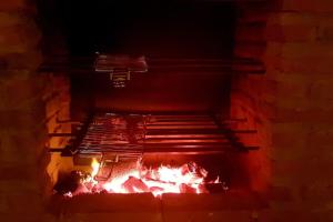 a brick oven with fire in it at night at Casa FLOREAL Icaraizinho de Amontada wifi in Icaraí