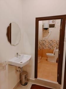 a bathroom with a sink and a toilet at Hotel Urban Sleep Airport Zone in Shamshabad