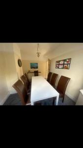 a dining room with a white table and chairs at 2 bed full house with private summer garden in Elswick