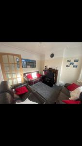 a living room with two couches and a television at 2 bed full house with private summer garden in Elswick