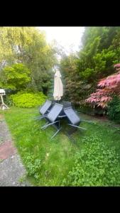 a table and chairs in a garden with a statue at 2 bed full house with private summer garden in Elswick