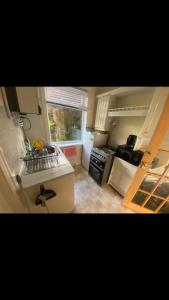 a kitchen with a sink and a stove top oven at 2 bed full house with private summer garden in Elswick