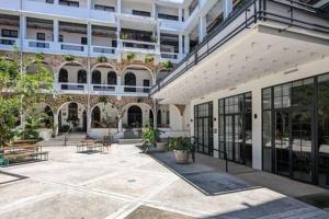a building with a courtyard with benches in front of it at Outstanding 1BR in Santa Ana in Panama City