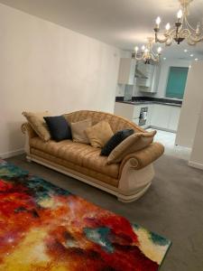 a living room with a couch and a rug at Pristine 3-Bed House in Grays in West Thurrock