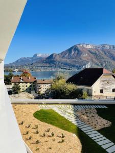 a view from the balcony of a building with a mountain at View Point Lake and Mountains in Annecy