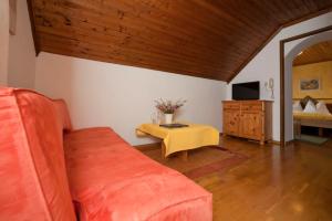 a living room with a couch and a table at Gourmetbauernhof Mentebauer in Gmünd in Kärnten