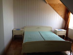 um quarto com uma cama e duas mesas de cabeceira em Balatoni Panoráma Villa em Balatonalmádi