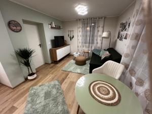 a living room with a couch and a table at Boarding House Alte Schusterei am Ahnepark in Vellmar