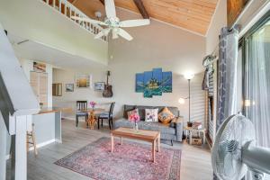 a living room with a couch and a table at Molokai Island Loft Lanai, Pool and Walk to Beach! in Kaunakakai