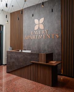 an office lobby with a sign on the wall at Emery Apartments in Pristina