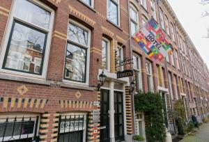 a brick building with flags on the side of it at Hotel Orion in Rotterdam