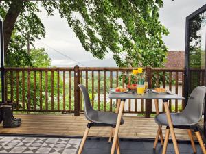 a table and chairs on a deck with food on it at 1 bed property in Gilwern Brecon Beacons 75206 in Gilwern
