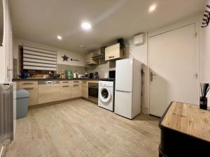 a kitchen with a refrigerator and a washing machine at Appartement 3 prsn Proche citadelle in Besançon