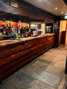 un bar con barra de madera en un restaurante en The Ancient Mariner, en Nether Stowey