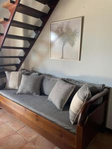 a couch with pillows sitting under a staircase at Villa Thea sitia in Sitia