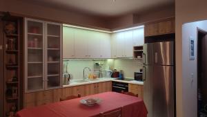 a kitchen with a table and a refrigerator at Lesvos Tavari bay 2 in Tavari