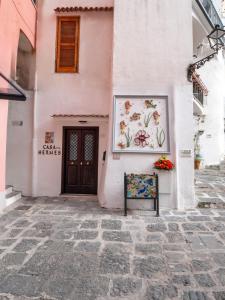a pink building with a picture of flowers on it at Casa Hermes in Atrani
