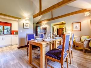 a dining room with a wooden table and chairs at 2 Bed in St Neots 79558 in Wyboston