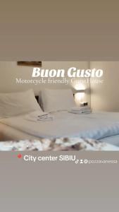 a bed with a sign that reads bien gustooficompatibleinally at Pensiunea Buon Gusto Sibiu-motorcyle friendly,city center in Sibiu